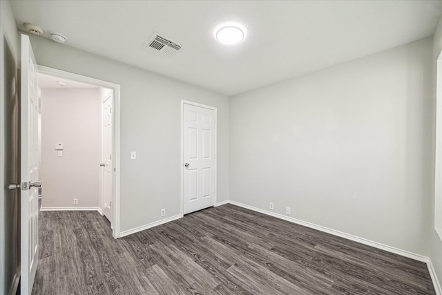 10410 Caribou Cv, Missouri City, TX 77459 - unfurnished bedroom with dark wood-style floors and baseboards