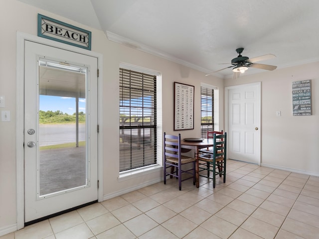 779 County Road 257, Matagorda, TX 77457 - dining area with ceiling fan, crown molding, baseboards, and light tile patterned floors