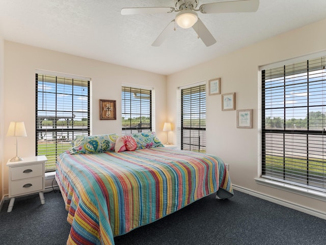 779 County Road 257, Matagorda, TX 77457 - bedroom featuring baseboards, carpet, and a ceiling fan
