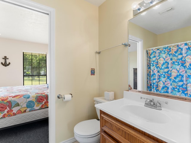 779 County Road 257, Matagorda, TX 77457 - full bathroom featuring toilet, vanity, and baseboards