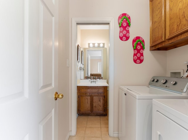779 County Road 257, Matagorda, TX 77457 - laundry area with cabinet space, independent washer and dryer, and light tile patterned floors