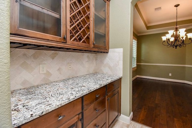17218 Meek Pass Dr, Cypress, TX 77433 - kitchen with crown molding, tasteful backsplash, light stone counters, glass insert cabinets, and baseboards