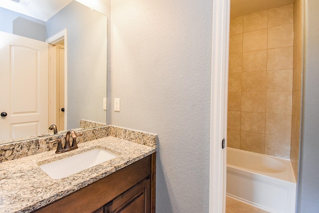 17218 Meek Pass Dr, Cypress, TX 77433 - full bathroom with vanity, a textured wall, and shower / bathtub combination