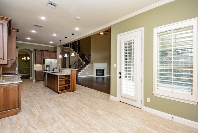 17218 Meek Pass Dr, Cypress, TX 77433 - kitchen featuring ornamental molding, a sink, an island with sink, open shelves, and a ceiling fan