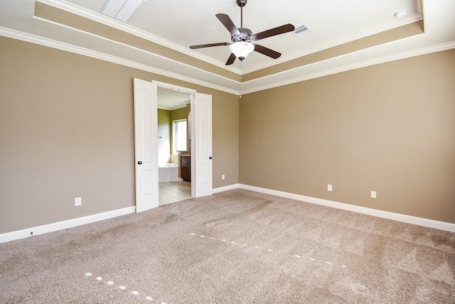 17218 Meek Pass Dr, Cypress, TX 77433 - spare room featuring ornamental molding, ceiling fan, light carpet, a tray ceiling, and baseboards