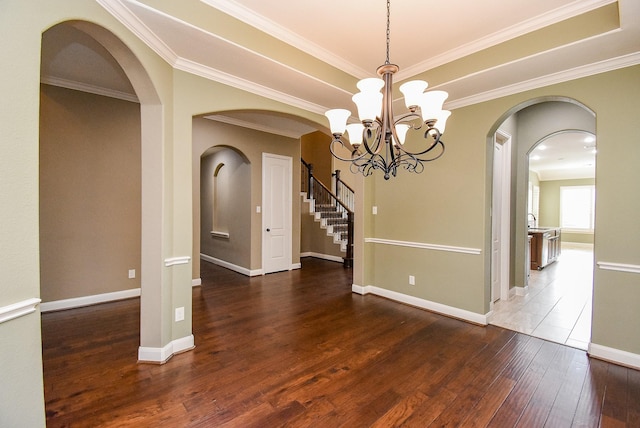17218 Meek Pass Dr, Cypress, TX 77433 - spare room featuring arched walkways, hardwood / wood-style floors, a chandelier, baseboards, and crown molding