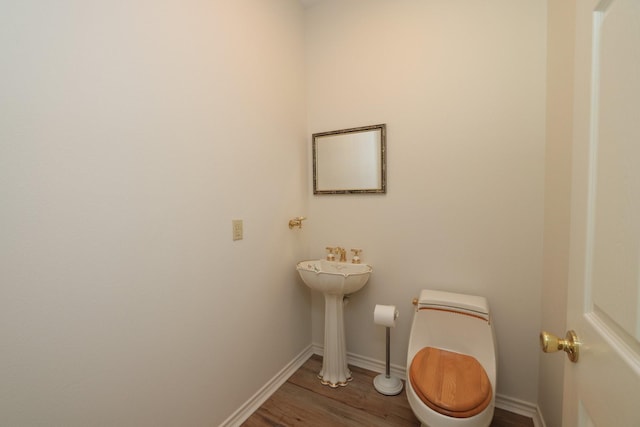 23302 Green Forest St, Hockley, TX 77447 - half bathroom featuring toilet, wood finished floors, and baseboards