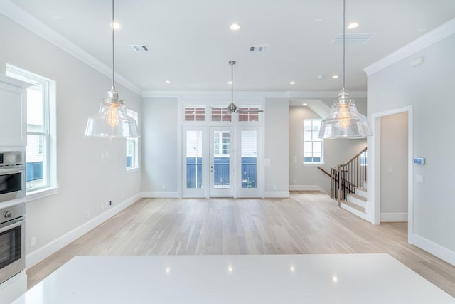 737 Bringhurst St, Houston, TX 77020 - unfurnished living room with crown molding, stairs, light wood-style flooring, baseboards, and a ceiling fan