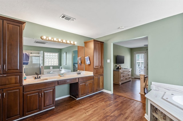 16703 Managua Way, Jamaica Beach, TX 77554 - full bath with wood finished floors, a garden tub, a shower stall, and healthy amount of natural light