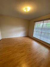 12633 Memorial Dr Unit 72, Houston, TX 77024 - empty room with wood finished floors