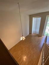 12633 Memorial Dr Unit 72, Houston, TX 77024 - unfurnished dining area with wood finished floors