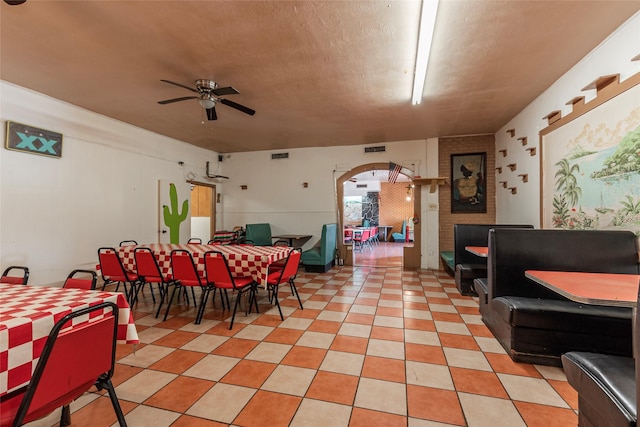 1309 1st St, La Marque, TX 77568 - dining space featuring a ceiling fan, arched walkways, and a textured ceiling