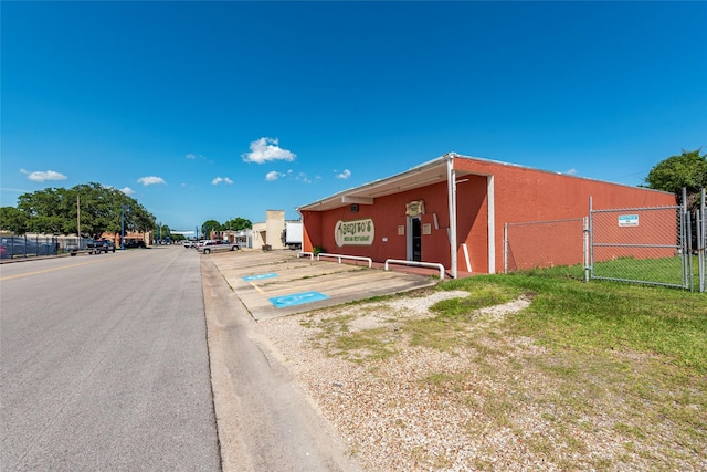 1309 1st St, La Marque, TX 77568 - view of asphalt road featuring curbs