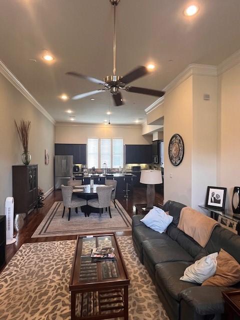 2533 Lamar St, Houston, TX 77003 - living area with crown molding, wood finished floors, ceiling fan, and recessed lighting