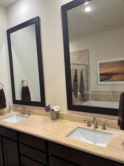 2533 Lamar St, Houston, TX 77003 - full bathroom featuring double vanity, a bath, a shower, and recessed lighting