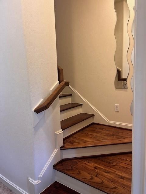 2533 Lamar St, Houston, TX 77003 - stairs with baseboards and wood finished floors