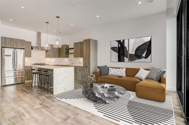 1211 Caroline St Unit 906, Houston, TX 77002 - living room featuring light wood-type flooring and recessed lighting