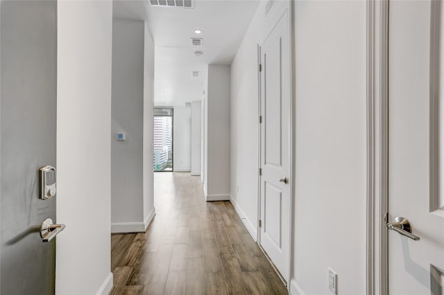 1211 Caroline St Unit 906, Houston, TX 77002 - hallway featuring wood finished floors and baseboards