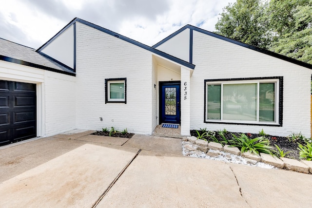 6335 Portal Dr, Houston, TX 77096 - view of front facade with brick siding and an attached garage