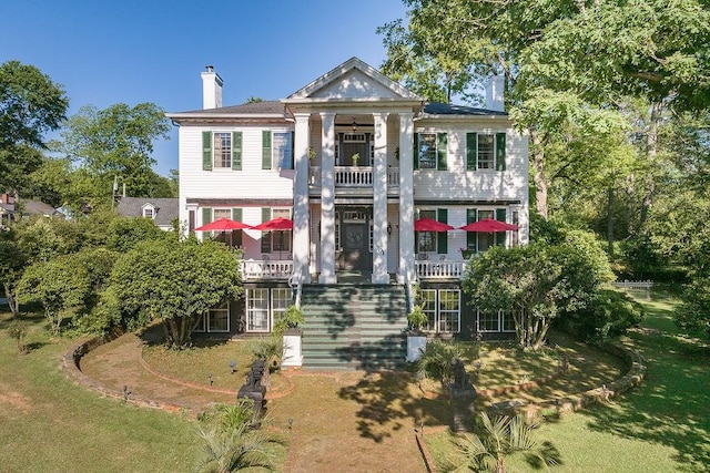 301 S Alexander Ave, Washington, GA 30673 - greek revival inspired property featuring a chimney, a balcony, stairway, and a front yard