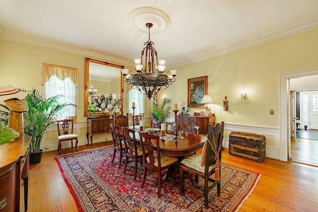 301 S Alexander Ave, Washington, GA 30673 - dining area with a chandelier, ornamental molding, light wood-type flooring, and a wainscoted wall