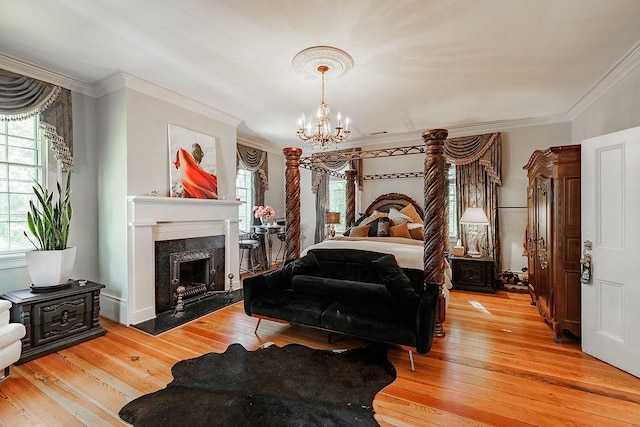 301 S Alexander Ave, Washington, GA 30673 - bedroom with light wood-type flooring, a chandelier, crown molding, and a high end fireplace