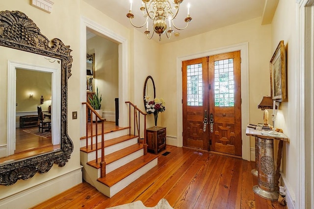 301 S Alexander Ave, Washington, GA 30673 - entrance foyer featuring hardwood / wood-style floors, a chandelier, and stairway