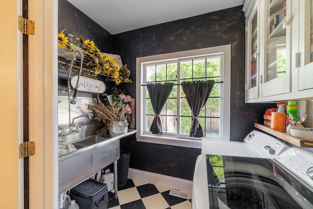 301 S Alexander Ave, Washington, GA 30673 - laundry area with cabinet space, washing machine and clothes dryer, tile patterned floors, and plenty of natural light