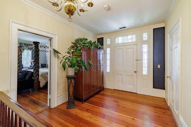 301 S Alexander Ave, Washington, GA 30673 - entryway featuring light wood-style floors, crown molding, a chandelier, and baseboards