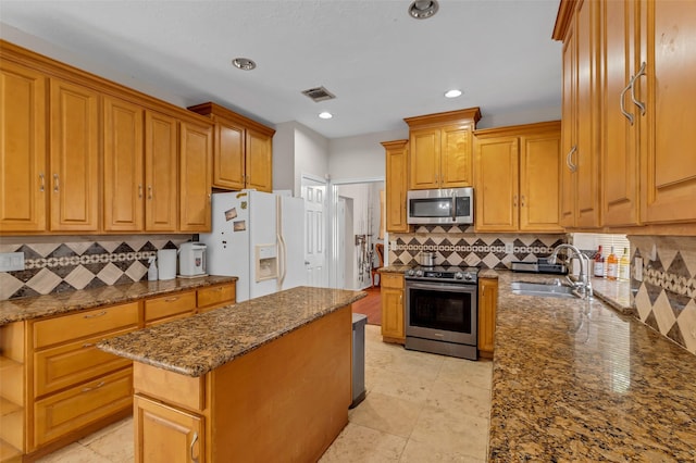 3714 Green Fields Dr, Sugar Land, TX 77479 - kitchen featuring appliances with stainless steel finishes, a sink, dark stone counters, tasteful backsplash, and recessed lighting
