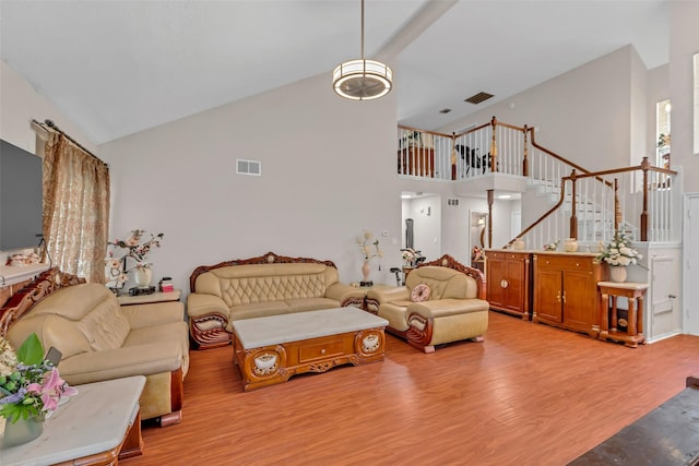 3714 Green Fields Dr, Sugar Land, TX 77479 - living area with light wood-type flooring, high vaulted ceiling, and stairs