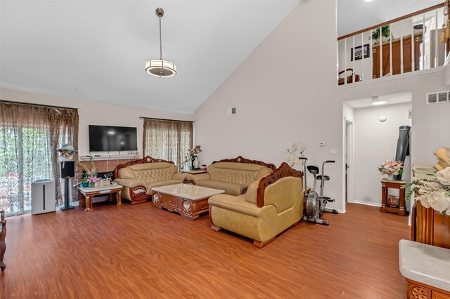 3714 Green Fields Dr, Sugar Land, TX 77479 - living room featuring high vaulted ceiling, wood finished floors, and baseboards