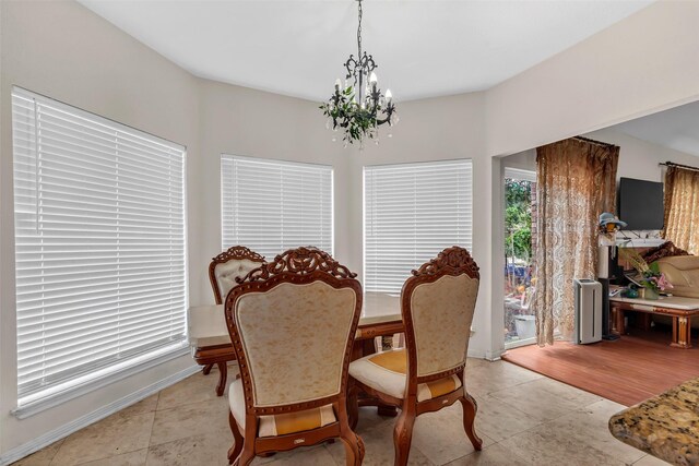 3714 Green Fields Dr, Sugar Land, TX 77479 - dining area featuring a chandelier, light tile patterned flooring, and baseboards