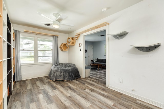 117 Tuna St, Galveston, TX 77550 - bedroom with wood finished floors and a ceiling fan