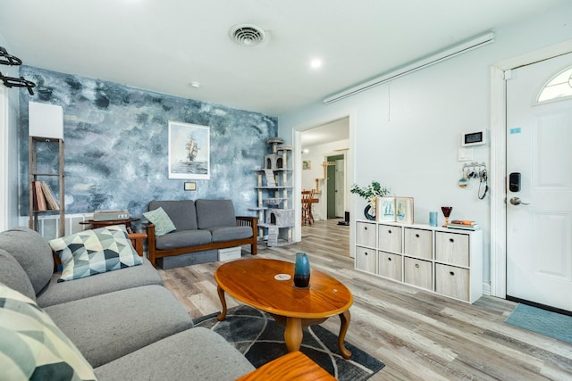 117 Tuna St, Galveston, TX 77550 - living area featuring wallpapered walls, light wood-type flooring, and an accent wall