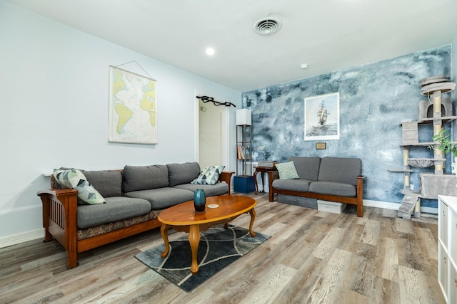 117 Tuna St, Galveston, TX 77550 - living room featuring wood finished floors, an accent wall, and wallpapered walls