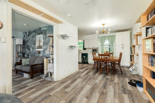 117 Tuna St, Galveston, TX 77550 - dining space featuring wood finished floors and a chandelier