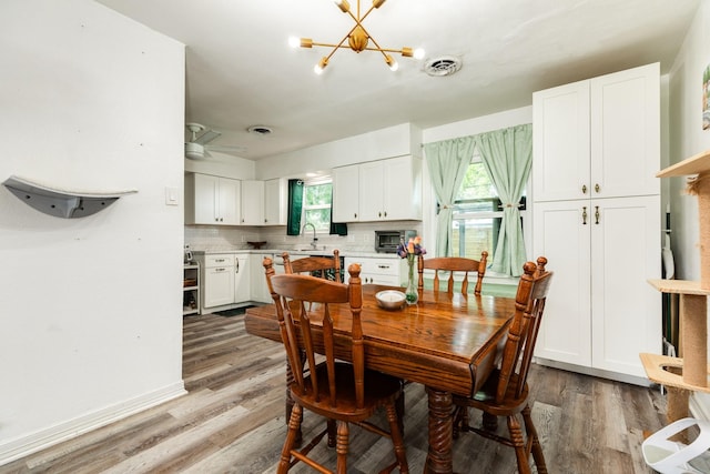 117 Tuna St, Galveston, TX 77550 - dining room featuring light wood-style flooring and a chandelier