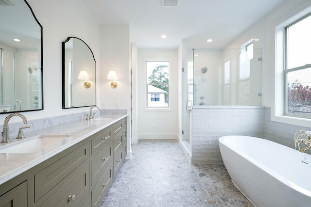 1438 Wakefield Dr, Houston, TX 77018 - bathroom featuring a shower stall, double vanity, a freestanding bath, and recessed lighting