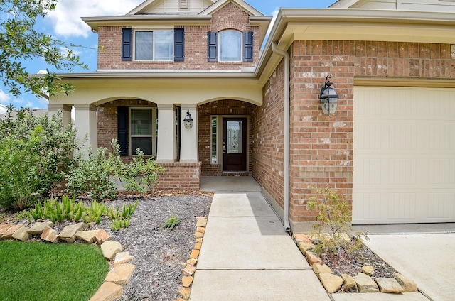 12902 Frontier Creek Ct, Tomball, TX 77377 - entrance to property with a garage, brick siding, and covered porch