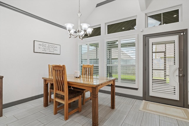 106 Comal Dr, Baytown, TX 77523 - dining room with a chandelier, vaulted ceiling, and baseboards