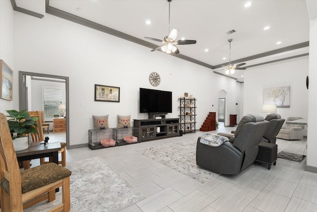 106 Comal Dr, Baytown, TX 77523 - living room featuring arched walkways, ceiling fan, recessed lighting, ornamental molding, and a towering ceiling