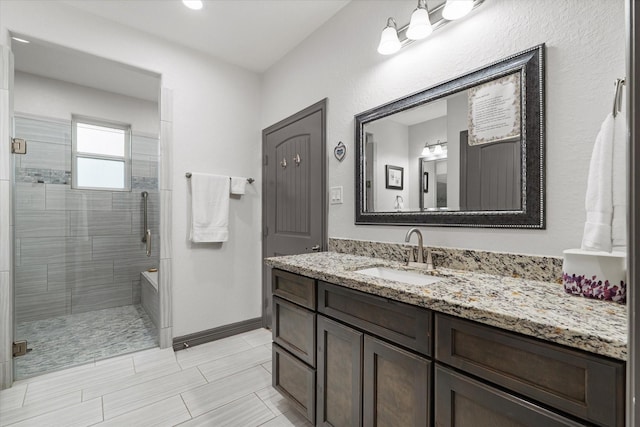 106 Comal Dr, Baytown, TX 77523 - full bath featuring a tile shower, vanity, and baseboards
