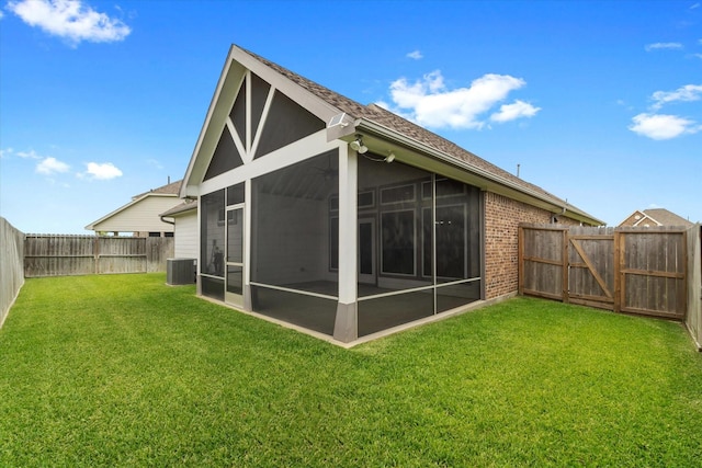 106 Comal Dr, Baytown, TX 77523 - back of property featuring a sunroom, central AC unit, brick siding, and roof with shingles