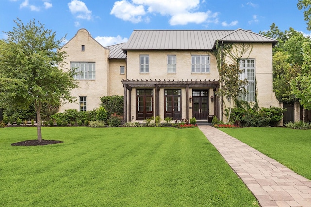 5420 Maple St, Bellaire, TX 77401 - view of front of house featuring a standing seam roof, a pergola, stucco siding, and a front yard