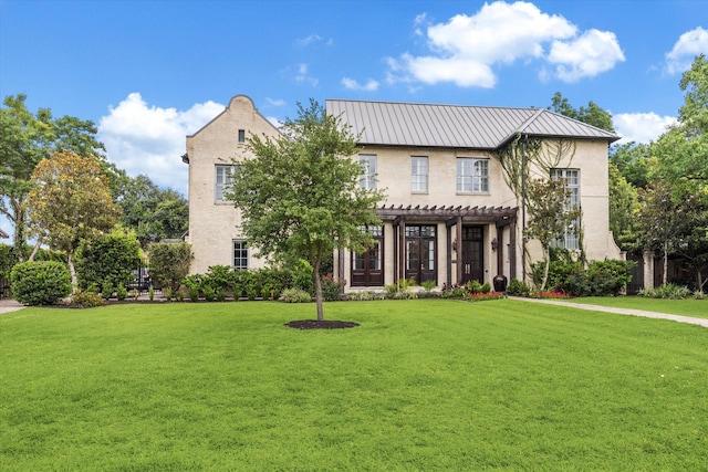 5420 Maple St, Bellaire, TX 77401 - view of front facade with a pergola, a front lawn, stucco siding, a standing seam roof, and metal roof