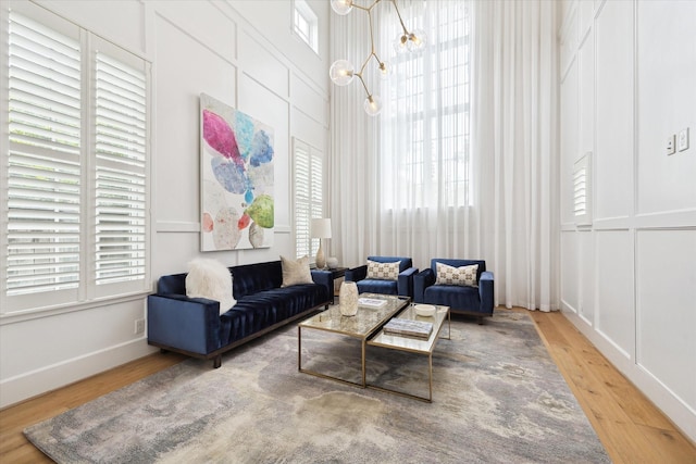 5420 Maple St, Bellaire, TX 77401 - living room featuring wood finished floors and a towering ceiling