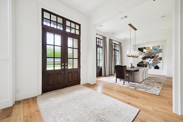 5420 Maple St, Bellaire, TX 77401 - foyer featuring french doors, hardwood / wood-style flooring, crown molding, a chandelier, and baseboards