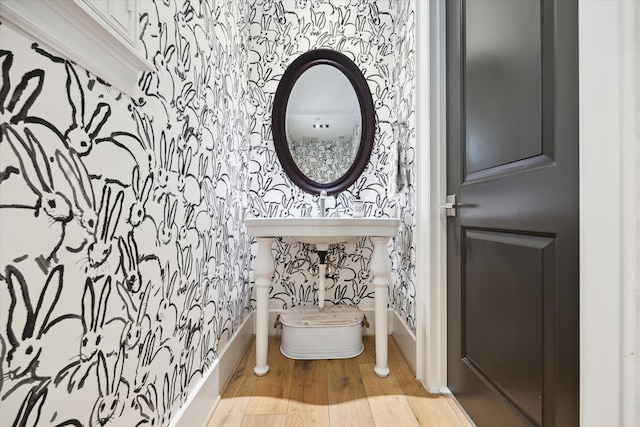 5420 Maple St, Bellaire, TX 77401 - bathroom with wallpapered walls, wood finished floors, and baseboards