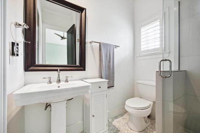 5420 Maple St, Bellaire, TX 77401 - bathroom featuring toilet, a shower stall, tile patterned floors, and baseboards